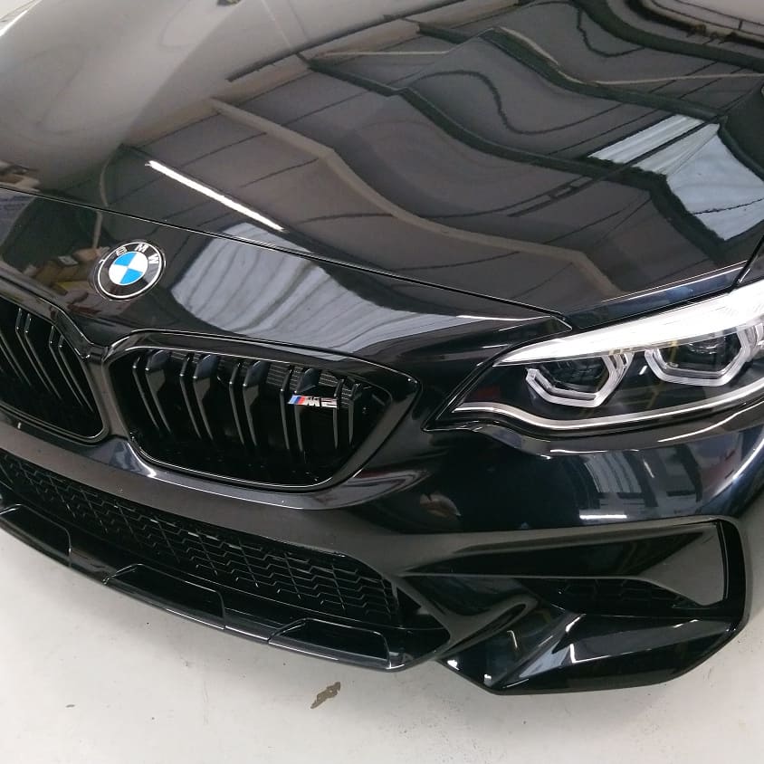 BMW M2 with paint protection film applied to the bonnet and front bumper, providing protection from stone, bird poop and general road debris from damaging the paintwork. Tinting Express Barnstaple Devon