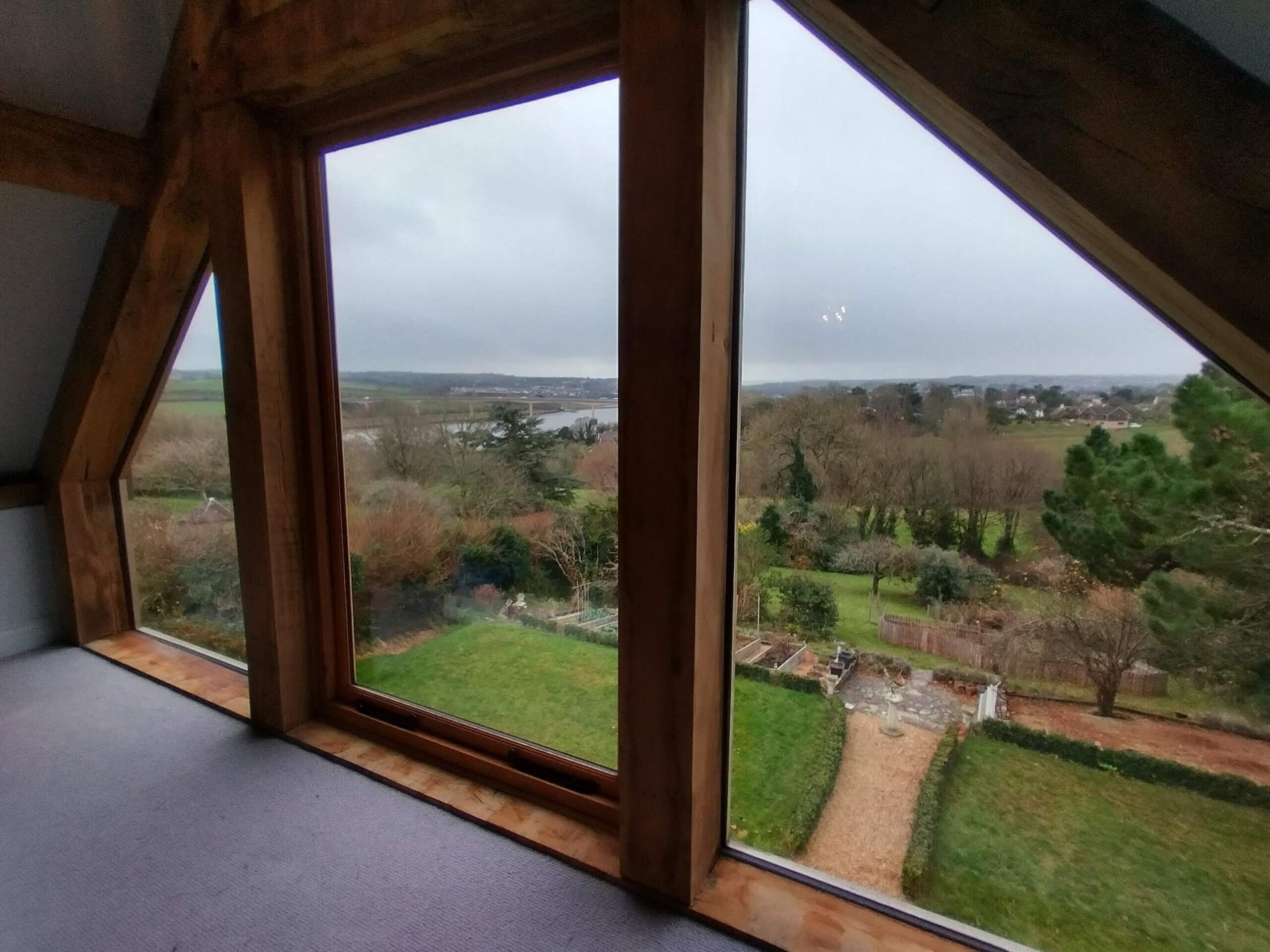 Gable End Oak Framed Window showing our Natural 70 solar window film applied to the glazing. Tinting Express Bideford