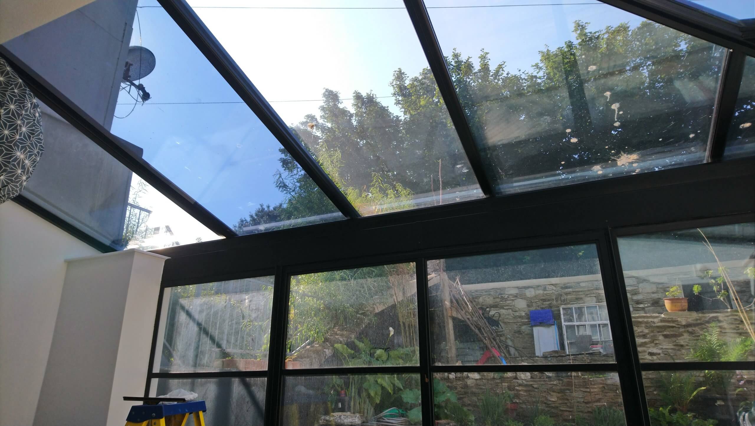 Glass extension to the kitchen. Solar window film application to the roof glass. Dual 15V film fitted. Blue tinted appearance. Tinting Express Barnstaple